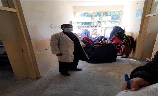 Community elders construct a waiting room for visitors in a Laghman health center